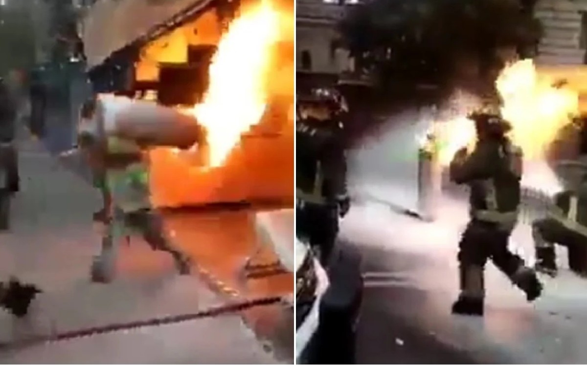 Bombero carga tanque de gas en llamas; evita una explosión