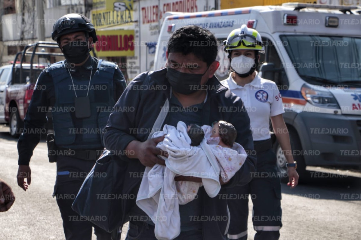 Un hombre carga dos figuras de Niño Dios que recuperó de su casa / Melanie Torres