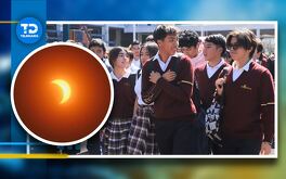 estudiantes en una escuela y un eclipse solar