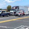 patrullas y un tráiler en la autopista
