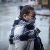 Mujer caminando con cubrebocas con lluvias y bajas temperaturas en la Ciudad de México. Mujer caminando con cubrebocas con lluvias y bajas temperaturas en la Ciudad de México.