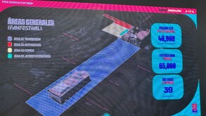 Una fotografía tomada de una pantalla digital (posiblemente en un evento) que muestra información y un mapa del 