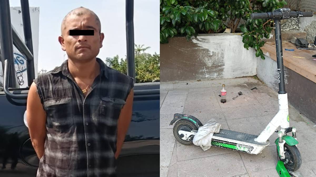 El hombre estaba dañando el scooter con una piedra El hombre estaba dañando el scooter con una piedra