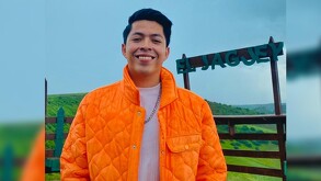 Edwin Gómez de 26 años posando con una chamarra naranja, tiene cáncer y pide apoyo.