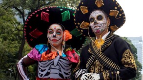 Personas vestidos de catrina y catrín de Día de Muertos en ediciones pasadas del desfile de Tlaquepaque
