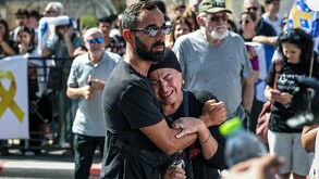 En la imagen aparecen dos personas, un hombre abrazando a una mujer que esta llorando, ambos traen atuendos en negro.