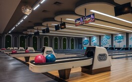 Pista clásica de madrea de boliche con dispensador de bolas de boliche y algunas pantallas y bolas