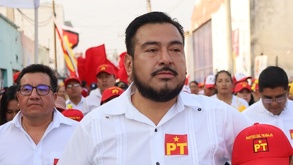 Hombre con barba encabeza una caravana con distintas personas vestidas con los colores blanco y rojo.
