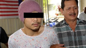 Hombre con playera blanca y gorra roja juntos a otro hombre de camisa de cuadros