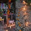 Una mujer y una niña montan una ofrenda de día de muertos en un terreno de lodo.