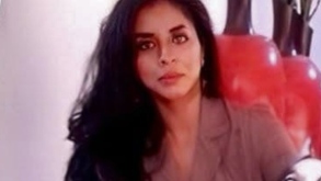 Mujer delgada mirando hacia una cámara para una fotografía.