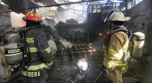 Elementos de Protección Civil y Bomberos de Jalisco en la bodega donde abandonada con múltiples objetos calcinados y escombro alrededor