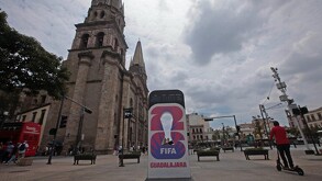 Una gran pantalla digital frente a la Catedral de Guadalajara y un templo en el centro histórico, muestra el logo del Mundial 2026 de la FIFA con el lema 