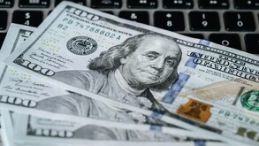 Dólares sobre el teclado de una computadora.