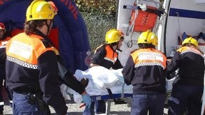 Cuerpos de rescate se aglutinan frnte a una camilla con una persona herida.