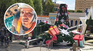 Piezas de árbol de navidad de gran tamaño desplomado en el suelo con vallas de seguridad y policías de Brasil alrededor