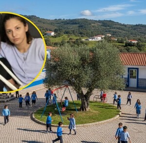 Niños vestidos de azul junto a un árbol al lado de salones de clase
