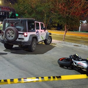 Moto tumbada en el pavimento con camioneta del IJCF y el camión de la ruta 637 detrás junto a unas personas paradas alrededor
