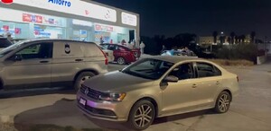 Se observa una fachada con el letrero de Farmacia del Ahorro y unos policías afuera del lugar.