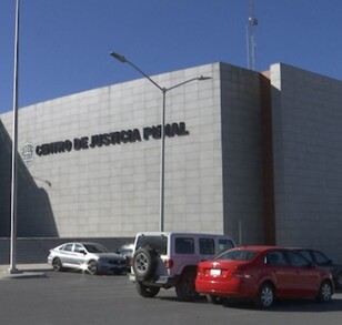 Se observa un edificio color gris que dice Centro de Justicia Penal.