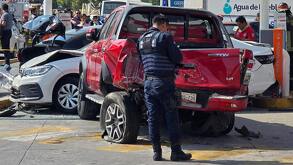 Un policía resguardando una zona donde hay varios vehículos accidentados en Puebla.