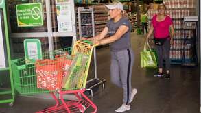 Mujer saliendo de Bodega Aurrera, en donde no reciben vales Mercomuna