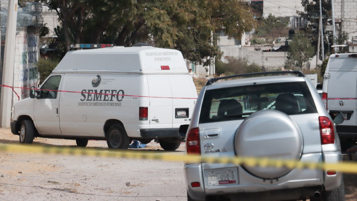 Vehículo del Semefo estacionado sobre de camino de terracería en San Francisco Totimehuacán, Puebla.