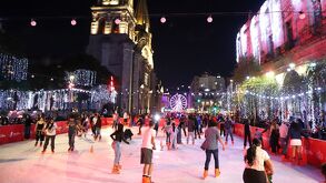 Personas patinando en pista de hielo en Guadalajara por la noche