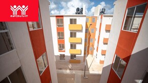 Fachadas de edificios de departamentos nuevos de interés social en colores blanco y naranja, con el logotipo oficial de Infonavit en la esquina.