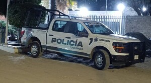 Vista lateral de una patrulla de la Policía Municipal de Tlaquepaque estacionada al exterior de la Cruz Roja Toluquilla durante la noche