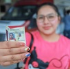 una mujer muestra su licencia de conducir de puebla