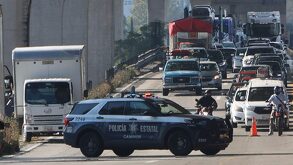 Una patrulla de policía detiene el tránsito en una autopista de Puebla.