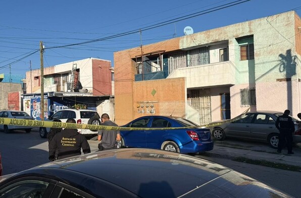 Se observan unas casas, unas personas afuera y una cinta amarilla de precaución.