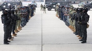 Se observa a varios hombres en filas vistiendo ropa color negra.