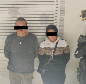 Se observa a dos personas detenidas, con cintilla negra en ojos, están detenidos.