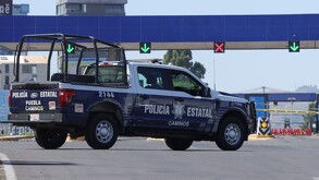 Patrulla de policía estacionada a unos metros de la caseta de cobro de la Autopista Puebla-Atlixco.
