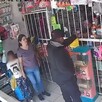 Asaltante recibiendo dinero de una cajera al interior de una papelería con una madre y su hija observando a la izquierda