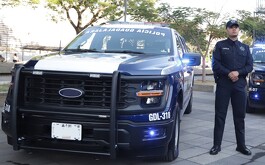 Policía junto a su patrulla en un evento en Guadalajara