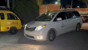 Se observa una camioneta tipo Van color blanca en medio de la calle.