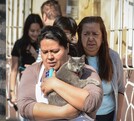 Mujer bajando a su gato tras la activación de la alerta sísmica.