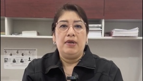 Mujer de lentes y chamarra negra habla para la cámara.