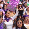 mujeres sostienen carteles en la marcha del 8 de marzo en puebla