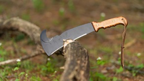 Un machete enterrado en la rama de un árbol.