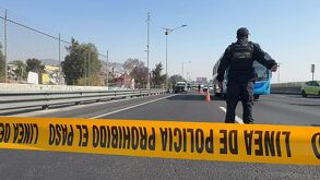 Policía acordona con cinta de seguridad una autopista de México.