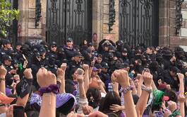 Mujeres y policías dentro dle marco 8M