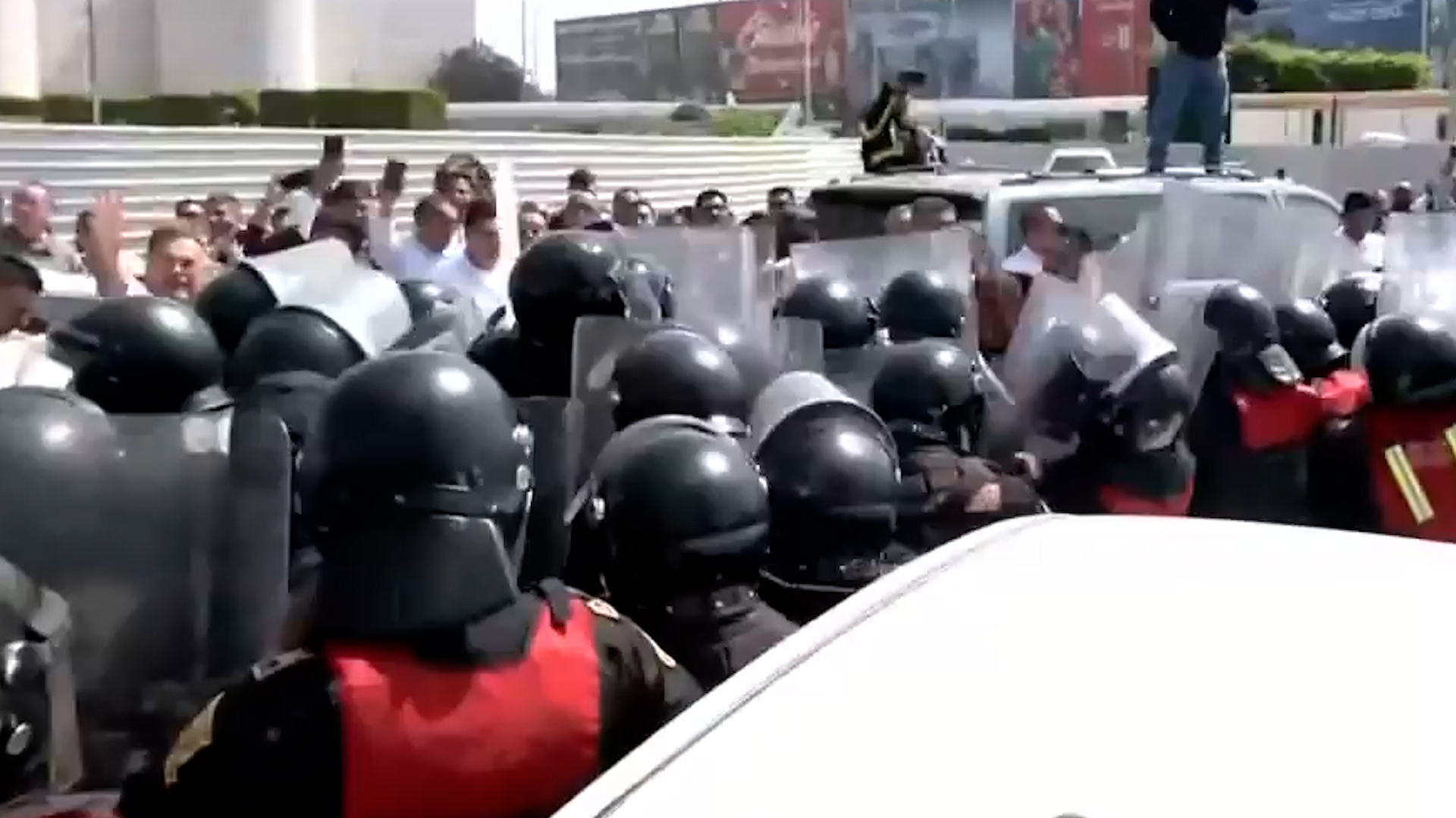 Taxistas bloquean la Terminal 2 del AICM y se enfrentan a la policía. Hay 6 detenidos y unidades arrastradas al corralón por el cierre de vialidades.