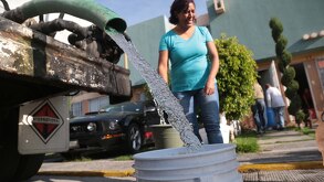 Pipa de agua llena las cubetas de las personas para tener de reserva en su hogar