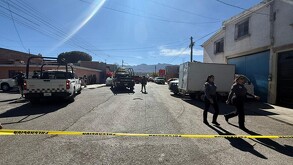 Se observa a varias mujeres con uniforme de policía caminando en la vialidad, hay una cintilla amarilla de precaución.