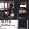 Personas viajando en un metrobús en Puebla vistas desde afuera.
