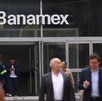 Personas caminando junto a una sucursal del banco Banamex en México.